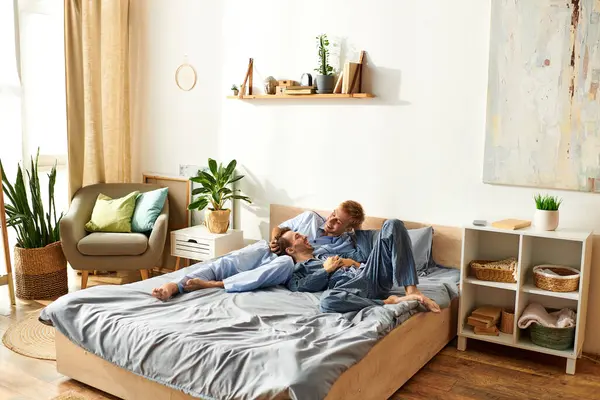 Deux partenaires profitent d'une matinée tendre, nichés ensemble en pyjama, entourés d'une maison chaleureuse et accueillante. — Photo de stock