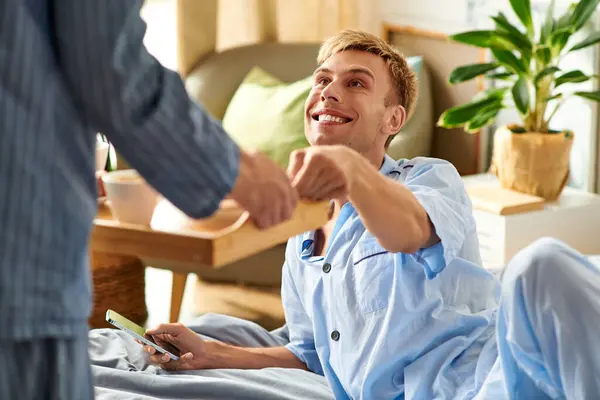 Two partners enjoy a delightful morning together, sharing smiles and warmth in their comfortable pajamas. — Stock Photo