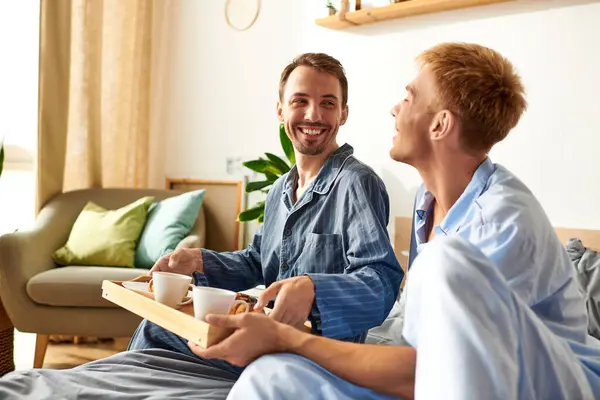 A loving couple enjoys a cozy morning together, sharing breakfast in their pajamas, filled with warmth and joy. — Stock Photo