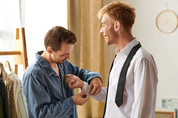 Two men enjoy a tender morning moment in their pajamas, sharing joy and connection in their cozy home. — Stock Photo