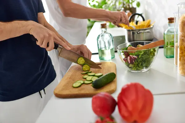 A loving gay couple prepares a vibrant salad in their modern kitchen — Stock Photo