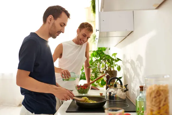 Two men happily collaborate in a bright kitchen, cooking and smiling at home — Stock Photo