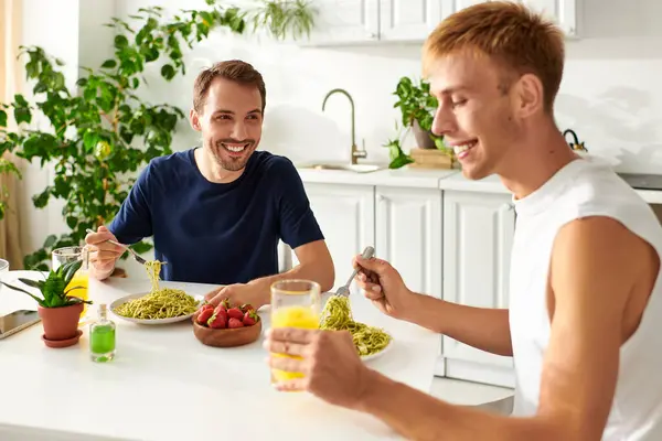 A loving couple shares a delightful moment as eating lunch in their stylish kitchen. — Stock Photo