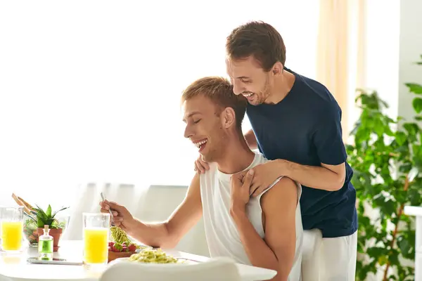 Una coppia felice che si abbraccia in una cucina elegante, condividendo risate e amore — Foto stock