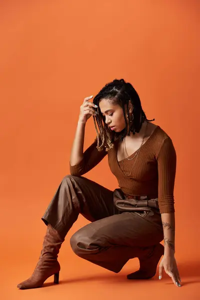 A trendy young woman with braided hair showcases her unique style in a creative studio setting. — Stock Photo