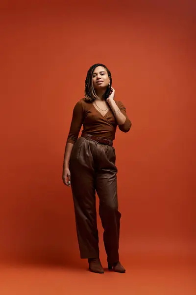 A fashionable African American woman showcases her braided hairstyle in a striking studio ambiance. — Stock Photo