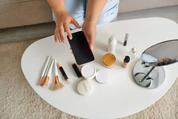 A young woman explores her beauty routine surrounded by makeup and skincare essentials. — Stock Photo