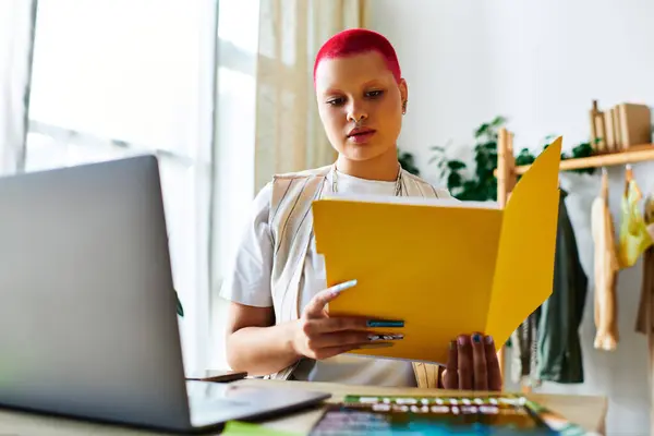 A focused young woman examines bright documents in her sunny home office, embracing creativity. — Stock Photo