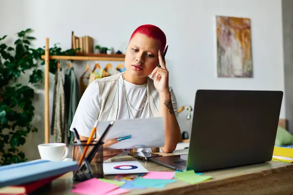 Engaged young woman contemplates her thoughts surrounded by art supplies at her workspace. — Stock Photo