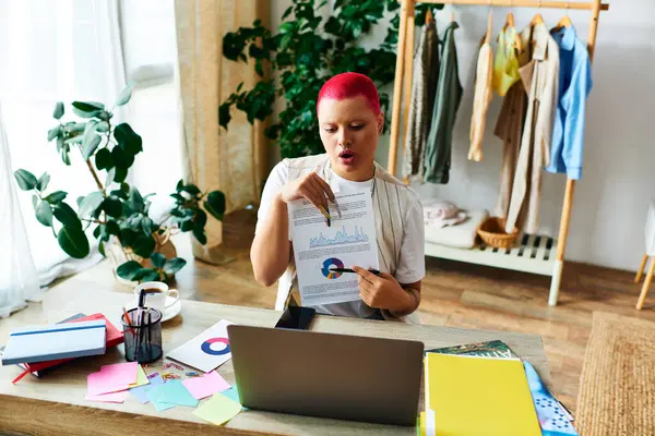 A woman interacts with her laptop while presenting visual data and colorful notes in her cozy space. — Stock Photo