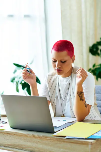 A woman with vibrant pink hair brainstorms ideas at her home workspace. — Stock Photo