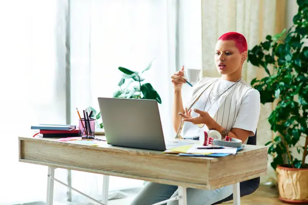 The young woman reflects with coffee in her plant filled home workspace. — Stock Photo