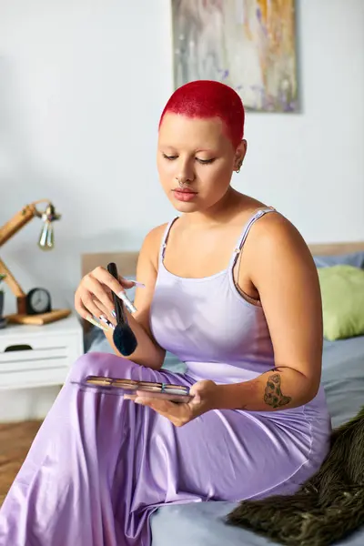 This young woman with striking red hair engages in her beauty routine, creating a calm atmosphere. — Stock Photo