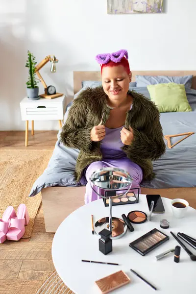 In a bright, welcoming room, a young woman smiles as she gets ready with her makeup collection. — Stock Photo