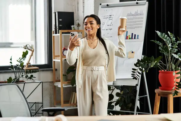 A cheerful professional shares ideas with colleagues in a trendy office over coffee. — Stock Photo