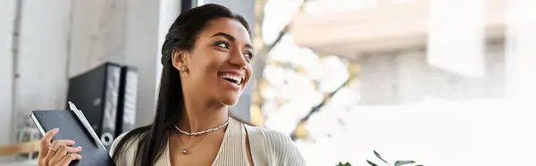 In a bright office, a young woman joyfully engages in her tasks, radiating positivity. — Stock Photo