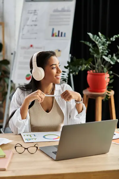 A confident young professional is immersed in her tasks at a stylish office space. — Stock Photo
