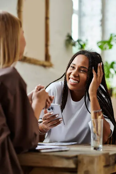 A loving multicultural couple enjoys each others company in a quaint cafe, sharing laughter and smiles. — Stock Photo