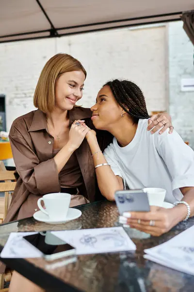 A smiling African American woman with braids enjoys a tender moment with her partner at a cafe. — Stock Photo