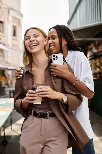 A happy multiethnic couple shares a warm moment at a cafe, with smiles and drinks, embracing their love. — Stock Photo