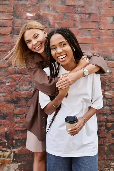 A smiling African American woman embraces her girlfriend, radiating love and happiness together. — Stock Photo