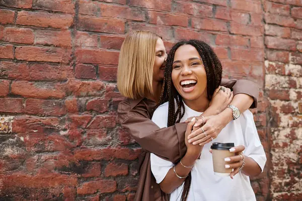 A smiling African American woman with braided hair enjoys a delightful moment with her girlfriend — Stock Photo
