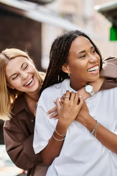 A smiling African American woman enjoys a tender moment with her girlfriend, radiating love. — Stock Photo