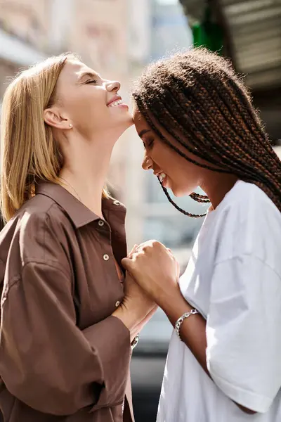 A smiling African American woman with braids shares a tender moment with her girlfriend — Stock Photo