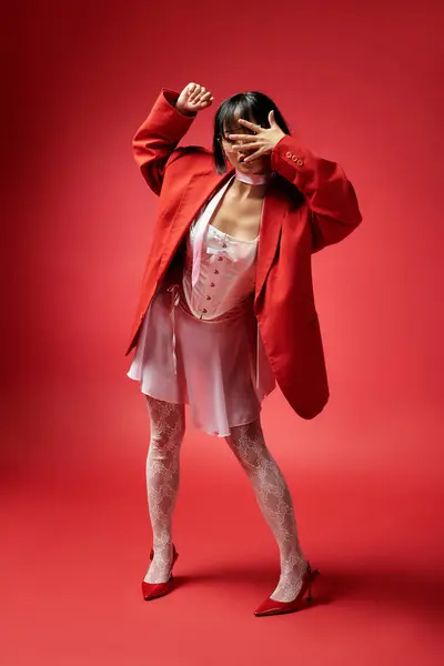 This captivating woman exudes confidence in her stunning red ensemble. — Stock Photo