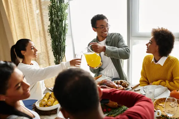 Friends gather at home for a Thanksgiving celebration filled with laughter and good food. — Stock Photo