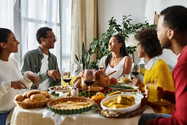 A warm gathering of friends sharing stories and a delightful Thanksgiving feast together. — Stock Photo