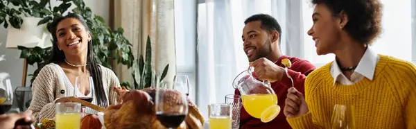 A group of friends enjoys a festive Thanksgiving meal filled with smiles and celebration. — Stock Photo
