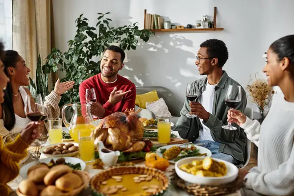 Friends joyfully celebrate Thanksgiving together with a festive, delicious meal. — Stock Photo