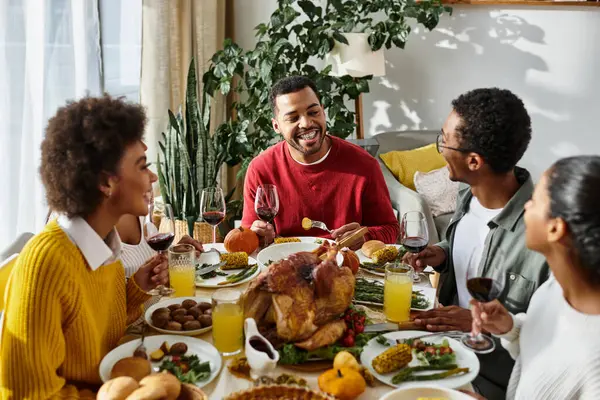 A group of friends shares joyful moments while enjoying a festive Thanksgiving feast together. — Stock Photo