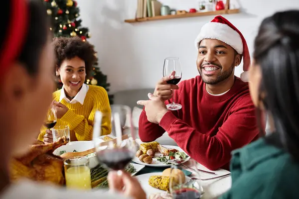 Friends share festive moments over a dinner filled with joy and holiday spirit at home. — Stock Photo