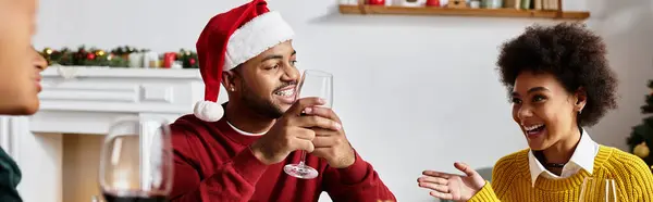 Festive gathering of friends sharing joyful moments over drinks and warm conversation. — Stock Photo