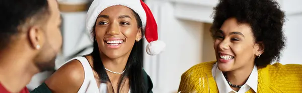 A group of friends enjoys Christmas together, sharing laughter and holiday spirit at home. — Stock Photo