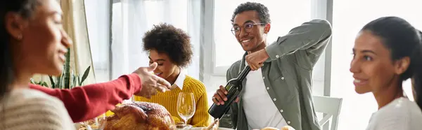 A group of friends share a festive Thanksgiving meal, filled with laughter and joy indoors. — Stock Photo