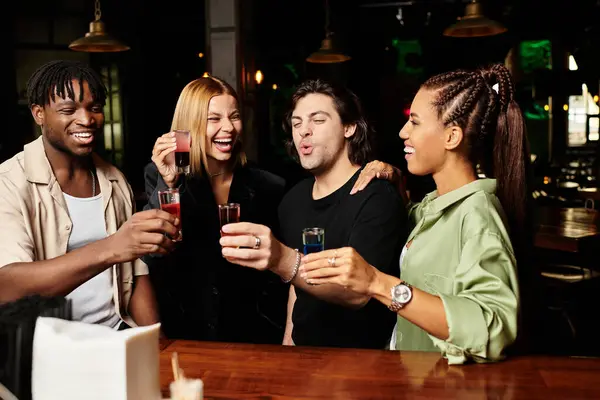 A vibrant group of colleagues sharing laughs while toasting with colorful drinks at a party. — Stock Photo