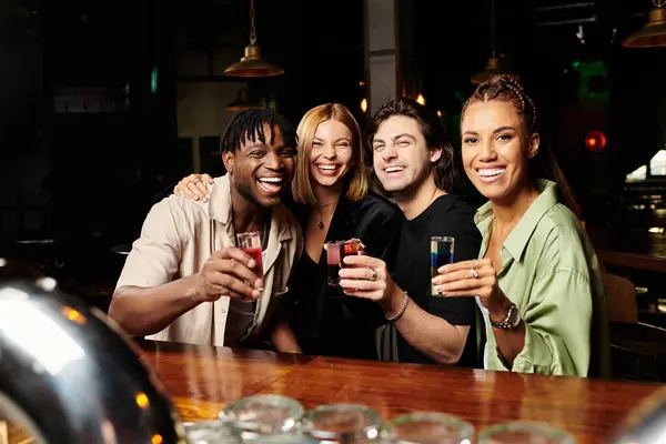 A cheerful group of young professionals toasts at a festive corporate event. — Stock Photo