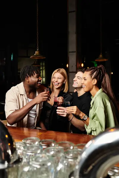 Young professionals share laughter and drinks at a vibrant corporate celebration. — Stock Photo