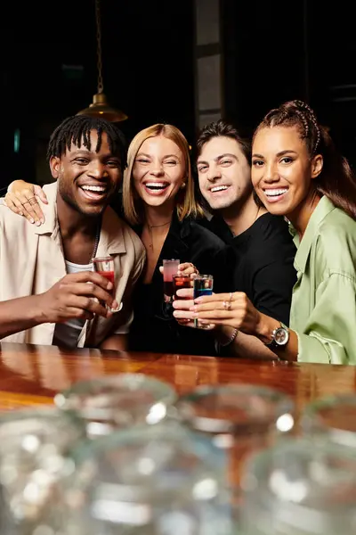 Colleagues celebrate success at a corporate gathering, sharing laughter and drinks together. — Stock Photo