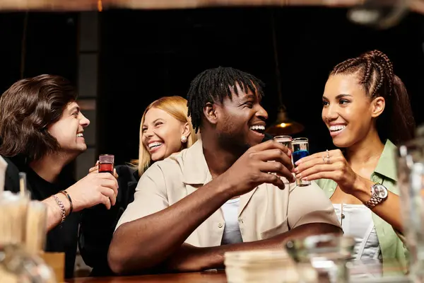 Young professionals enjoy each others company, sharing laughs and drinks during a vibrant party. — Stock Photo