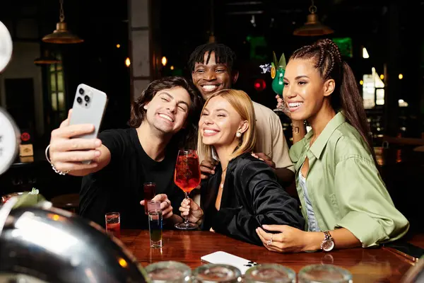 Young colleagues share smiles and capture memories at a lively corporate event. — Stock Photo
