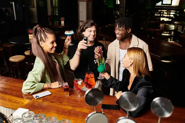 Colleagues enjoy a vibrant corporate party, raising drinks in celebration and friendship. — Stock Photo