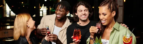 Colleagues enjoy drinks, sharing joyful moments together at a vibrant corporate gathering. — Stock Photo