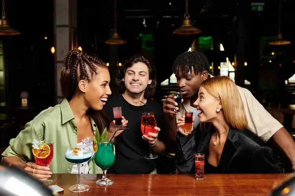 A lively gathering where young professionals celebrate, sharing drinks and laughter. — Stock Photo