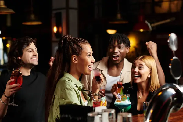 Colleagues celebrate together, raising colorful drinks and sharing laughter at a corporate event. — Stock Photo
