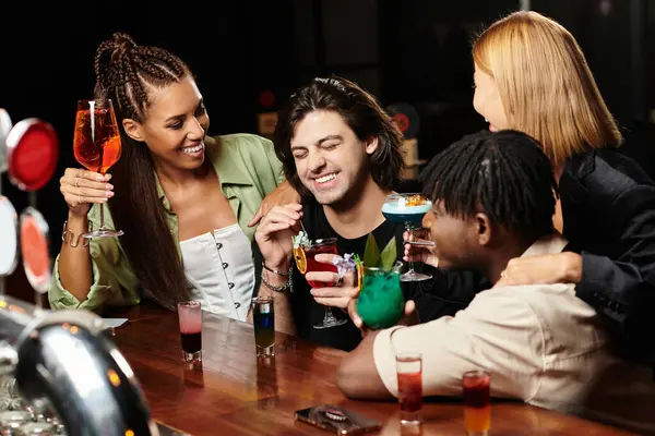 A lively gathering of diverse young professionals sharing drinks and joyful conversations together. — Stock Photo