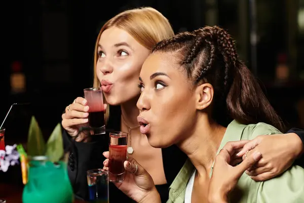 Young professionals share laughter and cocktails, building connections at a celebration. — Stock Photo